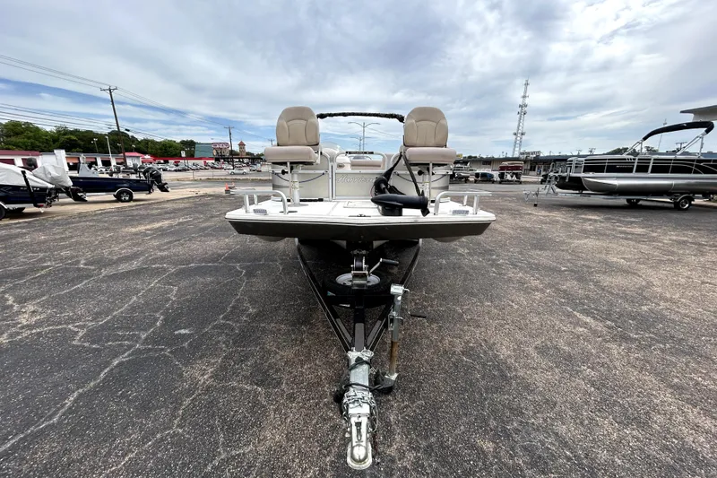 Slide: The Image of 2014 Hurricane FunDeck 226F boat on trailer, parked outdoors under cloudy sky. - 2