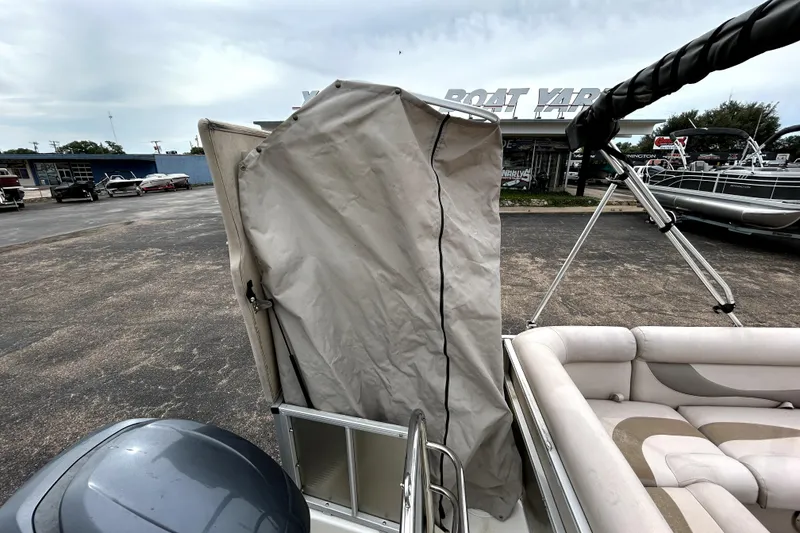 Slide: The Image of 2014 Hurricane FunDeck 226F boat with covered seating area at a boat yard. - 22