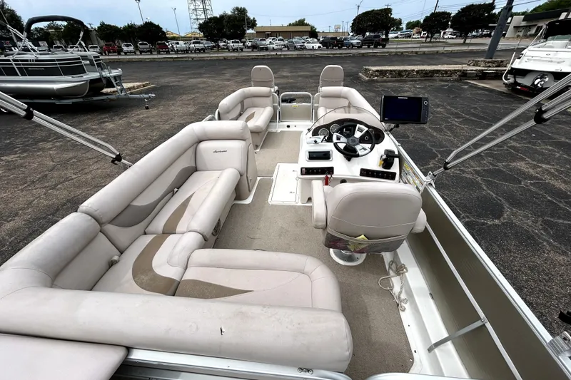 Slide: The Image of 2014 Hurricane FunDeck 226F boat interior with spacious seating and modern helm controls. - 23