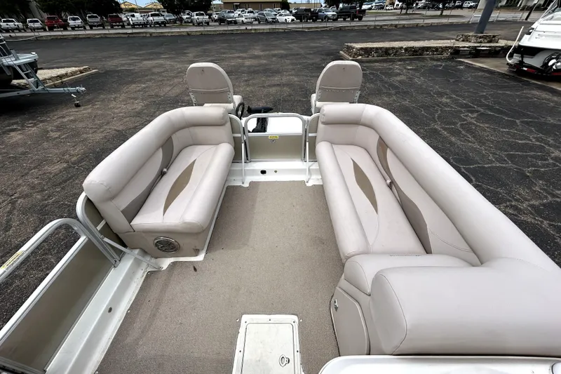Slide: The Image of 2014 Hurricane FunDeck 226F boat interior with beige seating and spacious layout. - 25
