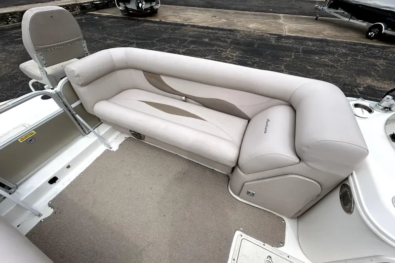 Slide: The Image of 2014 Hurricane FunDeck 226F boat interior with beige seating and carpeted floor. - 28