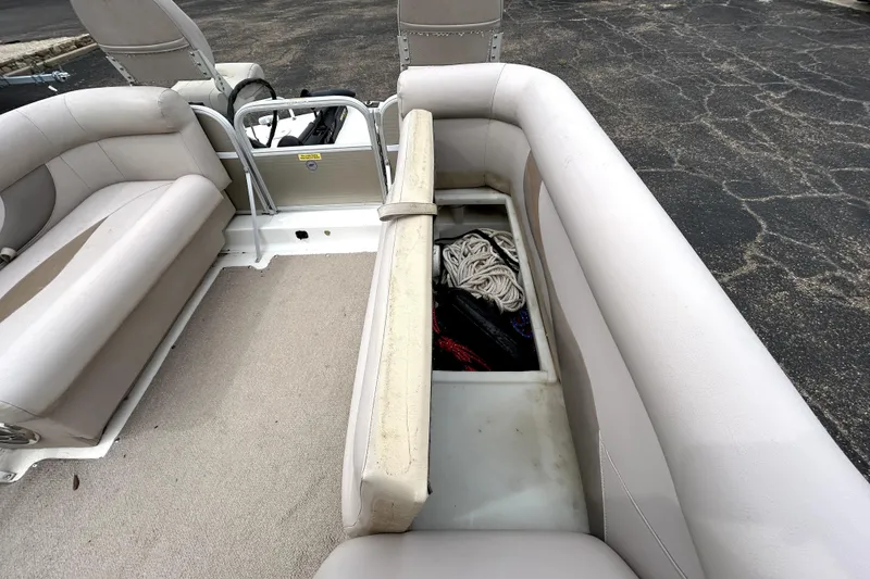 Slide: The Image of 2014 Hurricane FunDeck 226F boat interior with open storage compartment and seating. - 29