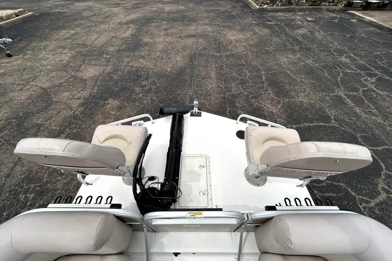 Slide: The Image of 2014 Hurricane FunDeck 226F boat with dual swivel seats on a paved surface. - 30