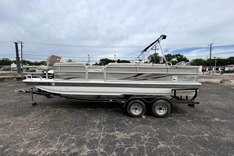 Slide: The Image of 2014 Hurricane FunDeck 226F boat on trailer in parking lot, side view. - 4