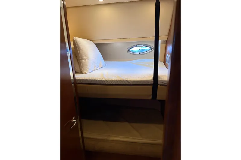 Slide: The Image of Cozy cabin interior of 2005 Meridian 490 Pilothouse yacht with porthole window. - 10