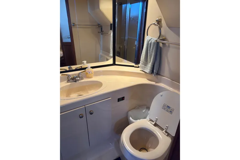 Slide: The Image of Bathroom interior of 2005 Meridian 490 Pilothouse yacht, featuring sink and toilet. - 11