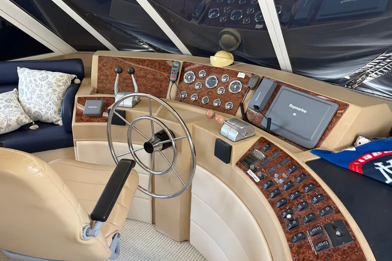 Slide: The Image of Pilothouse interior of 2005 Meridian 490, featuring steering wheel and navigation controls. - 13