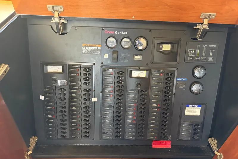 Slide: The Image of Electrical control panel of a 2005 Meridian 490 Pilothouse boat, featuring Onan GenSet. - 15