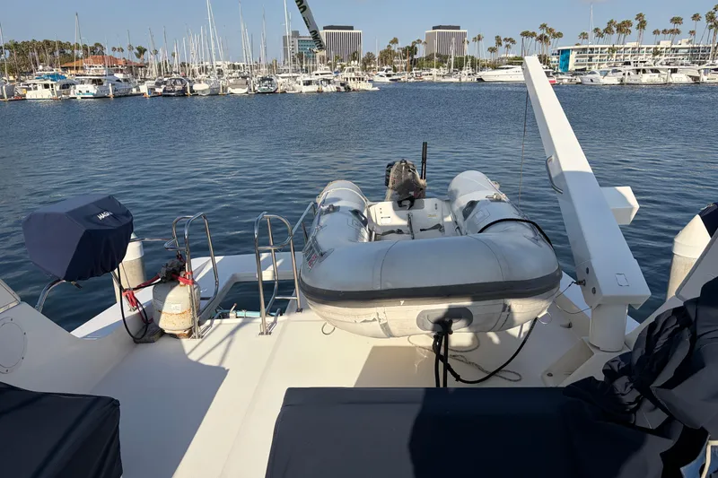 Slide: The Image of 2005 Meridian 490 Pilothouse yacht with inflatable dinghy docked at marina. - 16