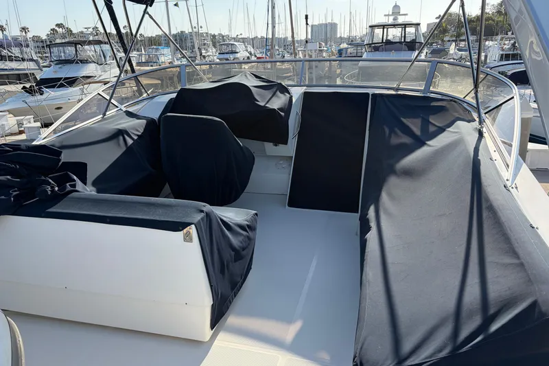 Slide: The Image of 2005 Meridian 490 Pilothouse yacht with covered seating area in marina setting. - 17
