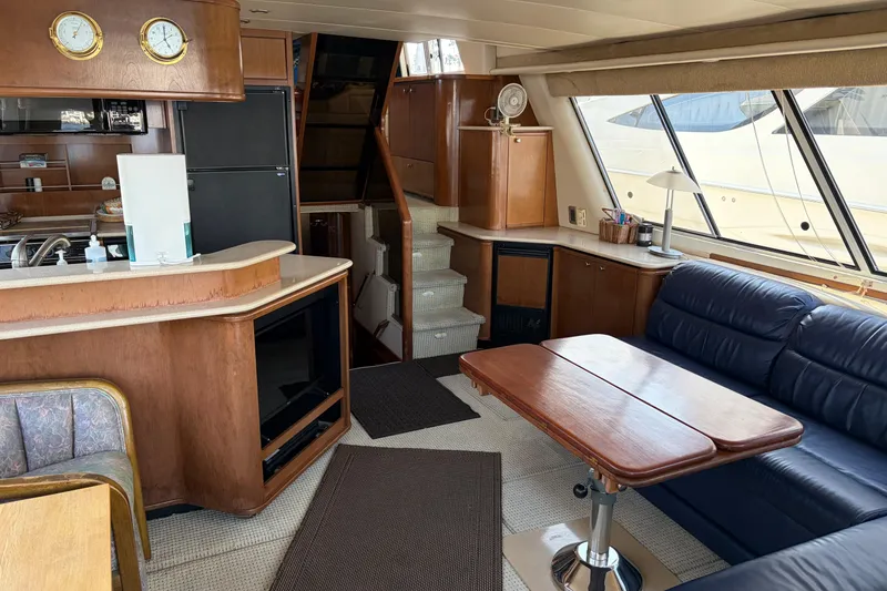 Slide: The Image of Interior of 2005 Meridian 490 Pilothouse yacht with kitchen, seating, and stairs. - 4