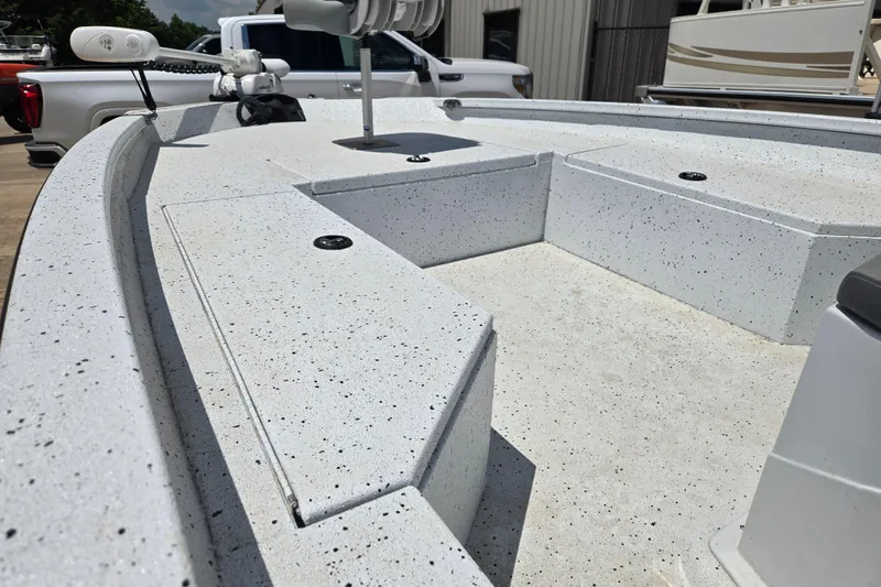 Slide: The Image of 2023 Xpress H22B Bay boat deck with speckled finish, featuring storage compartments. - 12