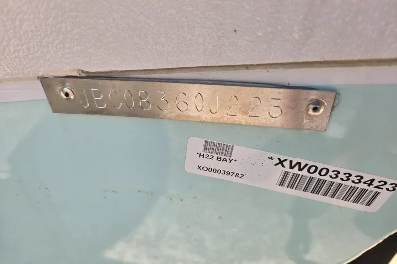 Slide: The Image of 2023 Xpress H22B Bay boat identification plate with serial number and barcode. - 18