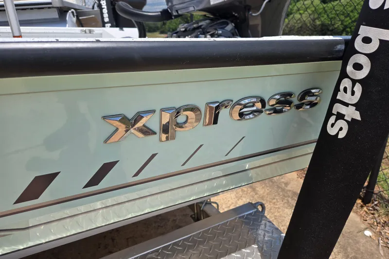 Slide: The Image of 2023 Xpress H22B Bay boat with chrome logo detail. - 4