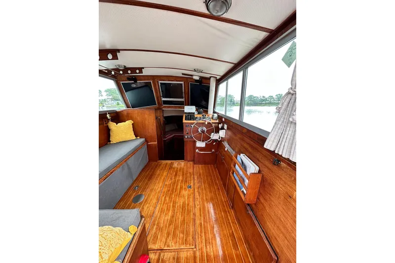 Slide: The Image of Interior of 1987 Cape Dory 28 Flybridge boat with wooden finish and helm station. - 3