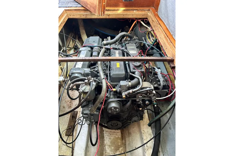 Slide: The Image of Engine compartment of a 1987 Cape Dory 28 Flybridge boat, showcasing detailed mechanics. - 8