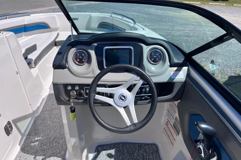 Slide: The Image of 2016 Chaparral Vortex 243 VRX boat dashboard with steering wheel and gauges. - 10