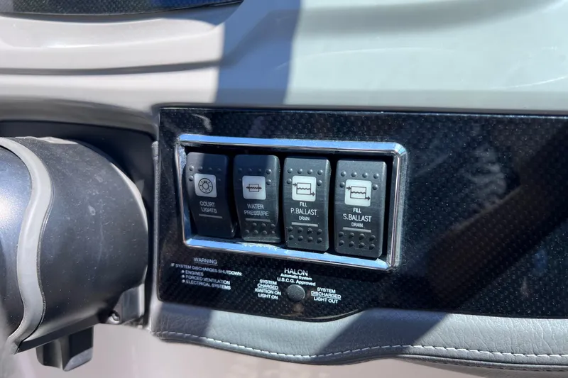 Slide: The Image of Control panel of a 2016 Chaparral Vortex 243 VRX boat with various switches. - 11