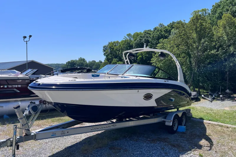 Slide: The Image of 2016 Chaparral Vortex 243 VRX boat on trailer, parked outdoors with trees in background. - 4