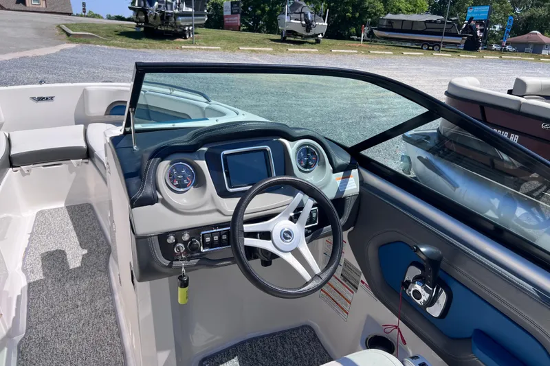 Slide: The Image of 2016 Chaparral Vortex 243 VRX boat interior with steering wheel and dashboard controls. - 9