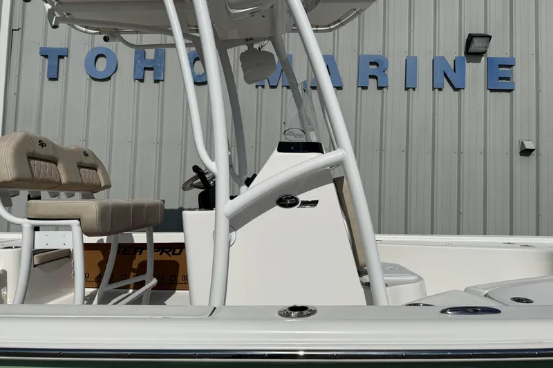 Slide: The Image of 2024 Sea Pro 210 Bay boat at Toho Marine dealership, featuring sleek design and seating. - 1