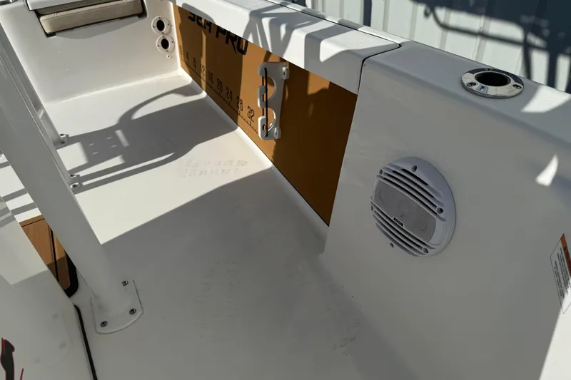 Slide: The Image of 2024 Sea Pro 210 Bay boat interior with speaker and rod holder. - 14