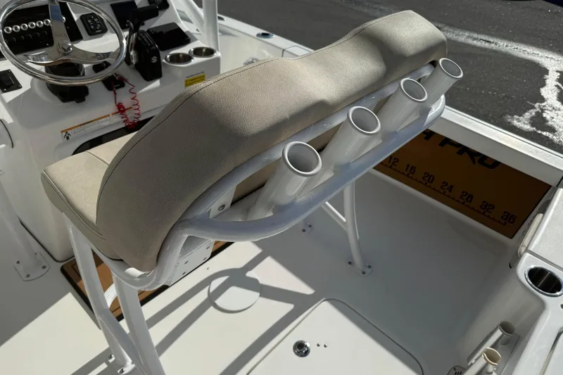 Slide: The Image of 2024 Sea Pro 210 Bay boat interior with rod holders and steering console. - 18
