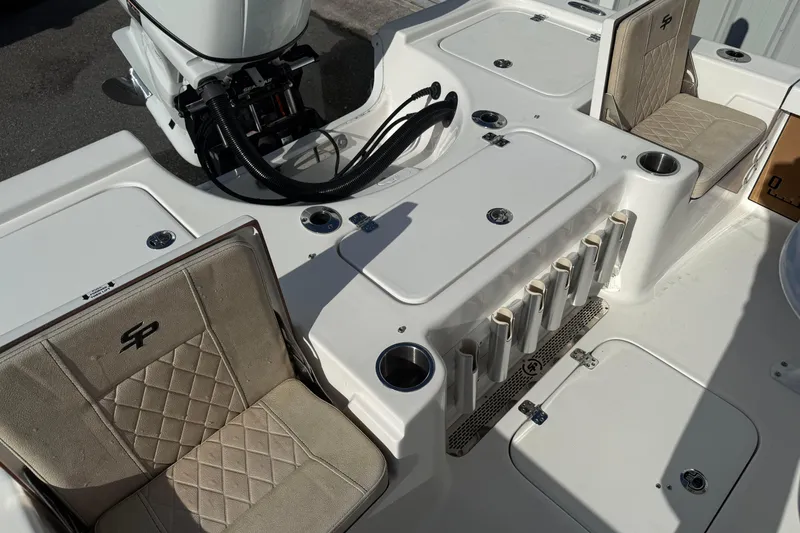 Slide: The Image of 2024 Sea Pro 210 Bay boat interior with seating and storage compartments. - 21