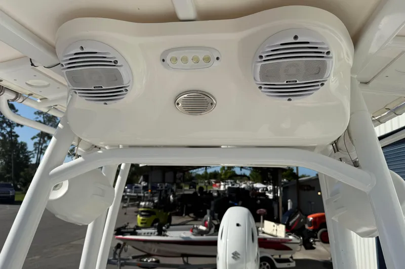 Slide: The Image of 2024 Sea Pro 210 Bay boat with mounted speakers and lights on the T-top. - 26