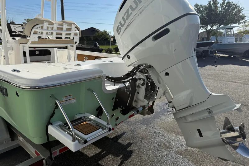 Slide: The Image of 2024 Sea Pro 210 Bay boat with Suzuki outboard motor, rear view in sunlight. - 6