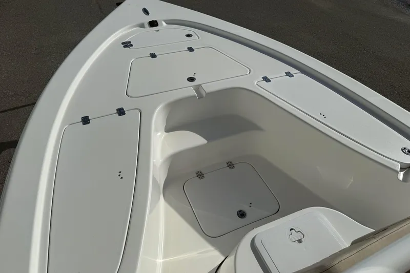 Slide: The Image of 2024 Sea Pro 210 Bay boat deck with storage compartments and sleek design. - 8