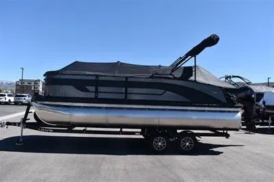 The Image of 2026 Lowe SF 212 Sport Fish pontoon boat with black canopy on a trailer. - 0