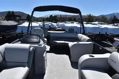 Slide: The Image of 2026 Lowe SF 212 Sport Fish pontoon boat with spacious seating and scenic mountain backdrop. - 13
