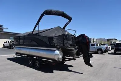 Slide: The Image of 2026 Lowe SF 212 Sport Fish pontoon boat on trailer, covered and ready for transport. - 2