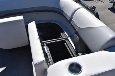 Slide: The Image of 2026 Lowe SF 212 Sport Fish boat interior with open storage compartment and cup holder. - 20