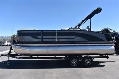 Slide: The Image of 2026 Lowe SF 212 Sport Fish pontoon boat on trailer, side view, clear sky background. - 5