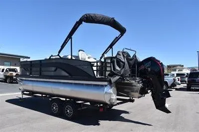 Slide: The Image of 2026 Lowe SF 212 Sport Fish pontoon boat on trailer, parked outdoors under clear blue sky. - 6
