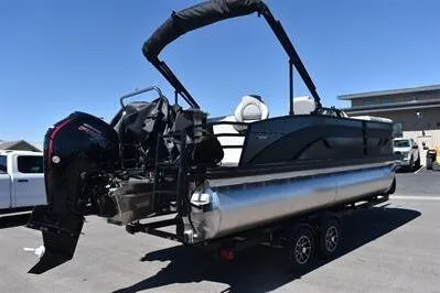 Slide: The Image of 2026 Lowe SF 212 Sport Fish pontoon boat on trailer, featuring sleek design and powerful outboard motor. - 7