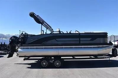 Slide: The Image of 2026 Lowe SF 212 Sport Fish pontoon boat on trailer, under clear blue sky. - 8