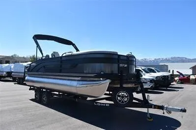Slide: The Image of 2026 Lowe SF 212 Sport Fish pontoon boat on trailer in parking lot. - 9