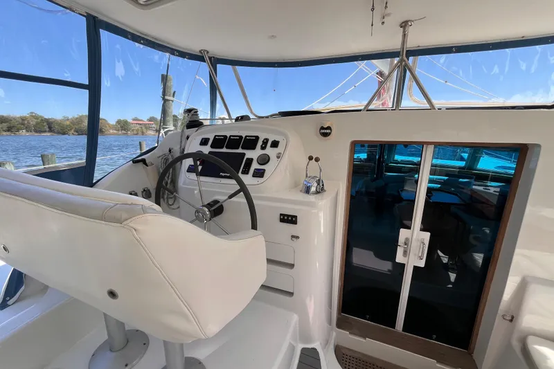 Slide: The Image of Helm of 2008 Broadblue 415 catamaran with steering wheel and navigation controls. - 12