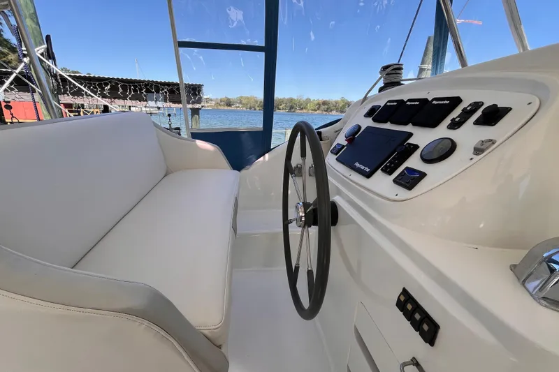 Slide: The Image of Helm of 2008 Broadblue 415 catamaran with steering wheel and navigation controls. - 13
