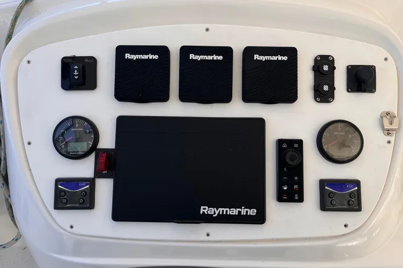 Slide: The Image of Control panel of a 2008 Broadblue 415 catamaran featuring Raymarine navigation equipment. - 14