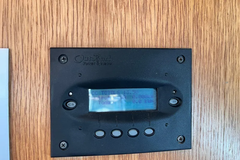Slide: The Image of OutBack Power Systems display on 2008 Broadblue 415 yacht, mounted on wooden panel. - 25