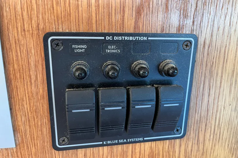 Slide: The Image of DC distribution panel on 2008 Broadblue 415 boat with switches for fishing light and electronics. - 27