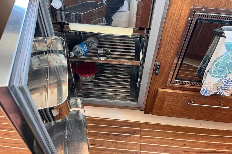 Slide: The Image of Open fridge on 2008 Broadblue 415 yacht with water bottle and food container. - 31