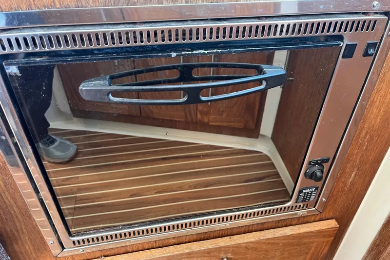 Slide: The Image of Built-in oven on a 2008 Broadblue 415 yacht, featuring a sleek design and wooden cabinetry. - 32