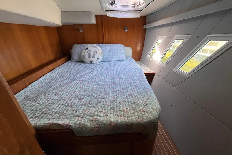 Slide: The Image of Cozy cabin interior of 2008 Broadblue 415 catamaran with bed and porthole windows. - 38