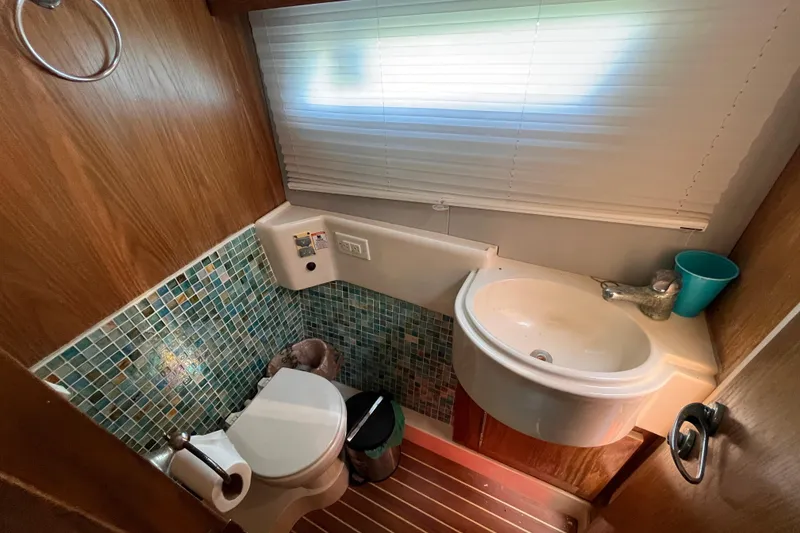 Slide: The Image of Compact bathroom in a 2008 Broadblue 415 yacht with mosaic tiles and modern fixtures. - 39