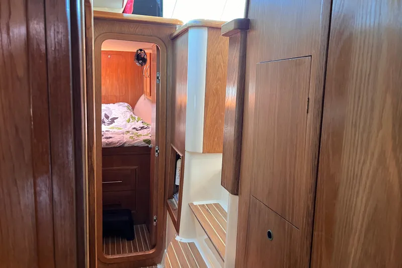 Slide: The Image of Interior of 2008 Broadblue 415 yacht, featuring wooden cabinetry and cozy sleeping quarters. - 44